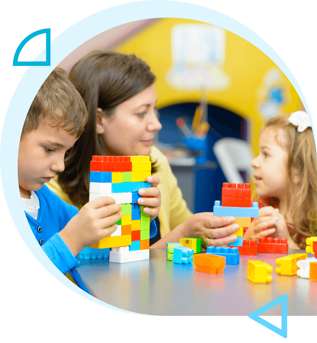 Children playing with colorful building blocks at a table.