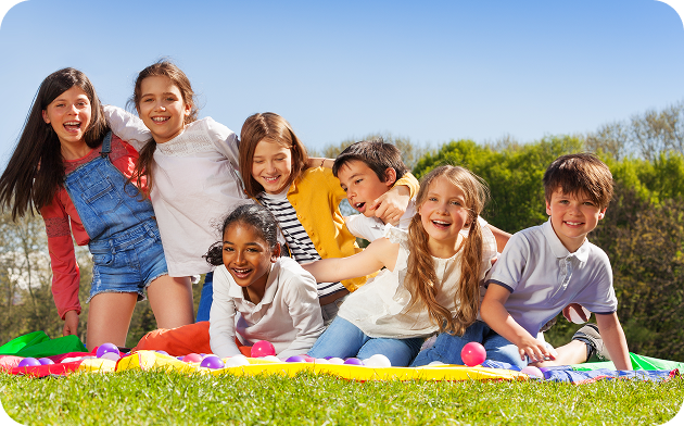 Children laughing together on a sunny day.