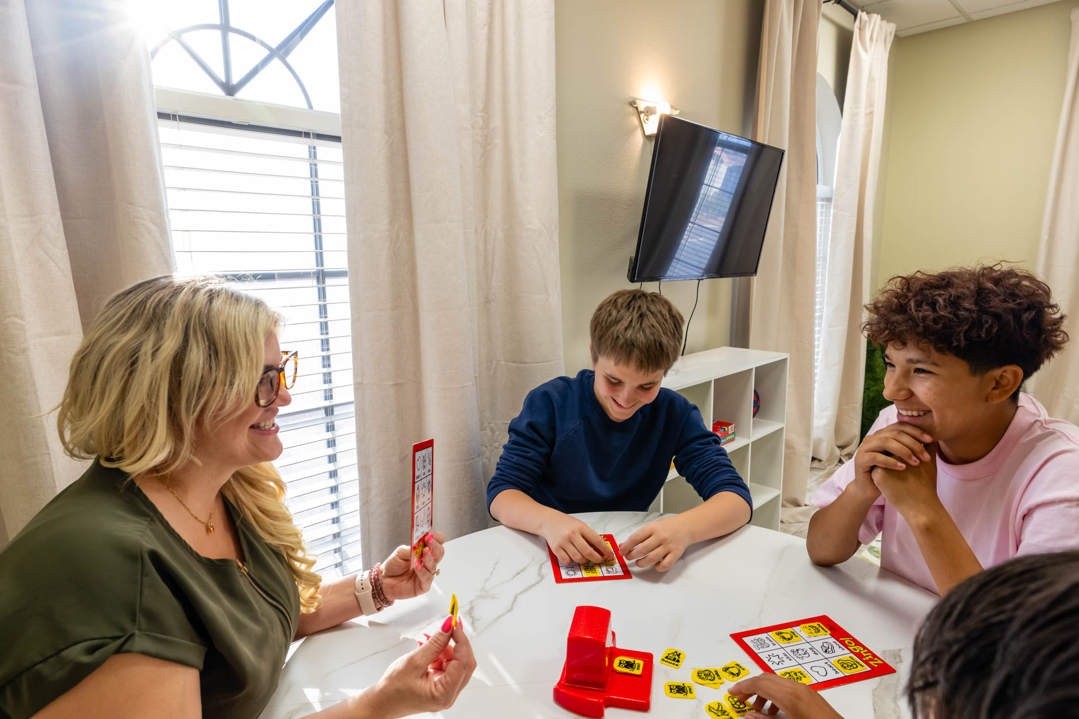 Family playing a board game together at home.